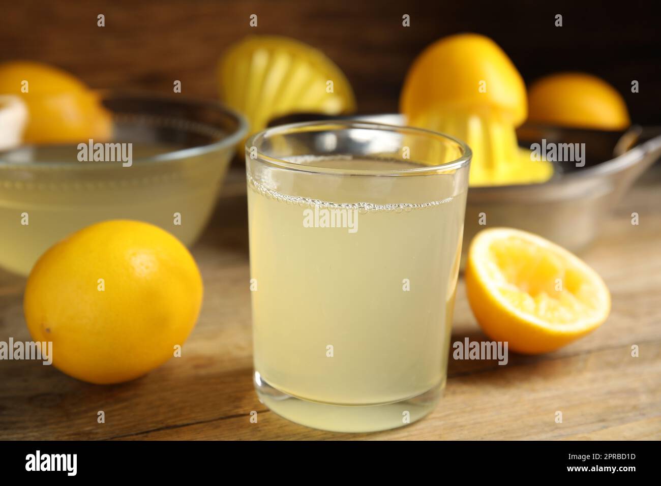 Freshly squeezed lemon juice on wooden table Stock Photo