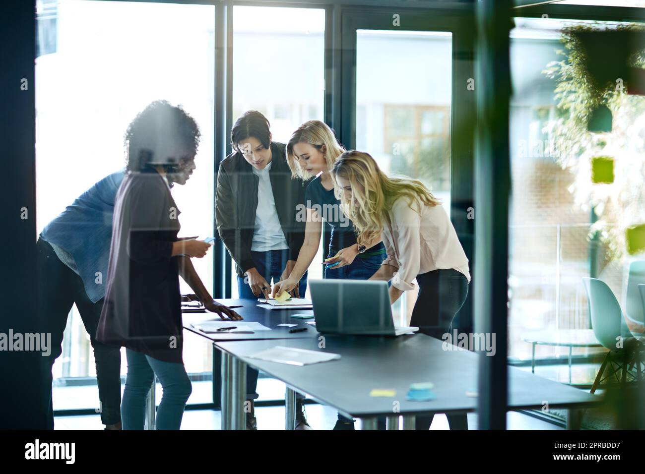 mMeting with team or group of businesspeople planning, brainstorming ideas and working on strategy for project in modern boardroom. Productive and diverse coworkers collaborating together Stock Photo