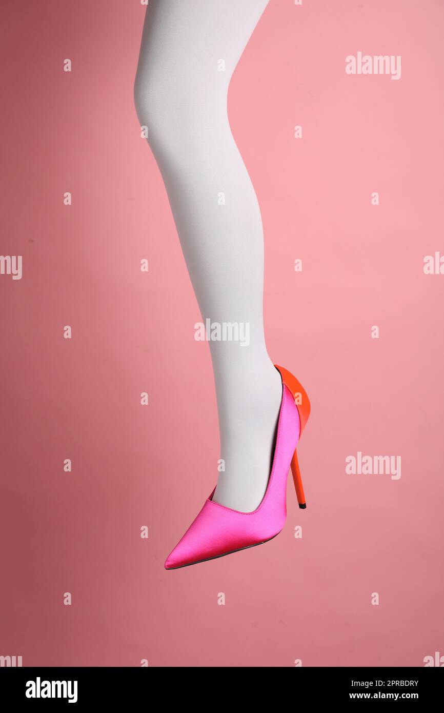 Woman wearing white tights and high heel shoe on pink background, closeup  Stock Photo - Alamy