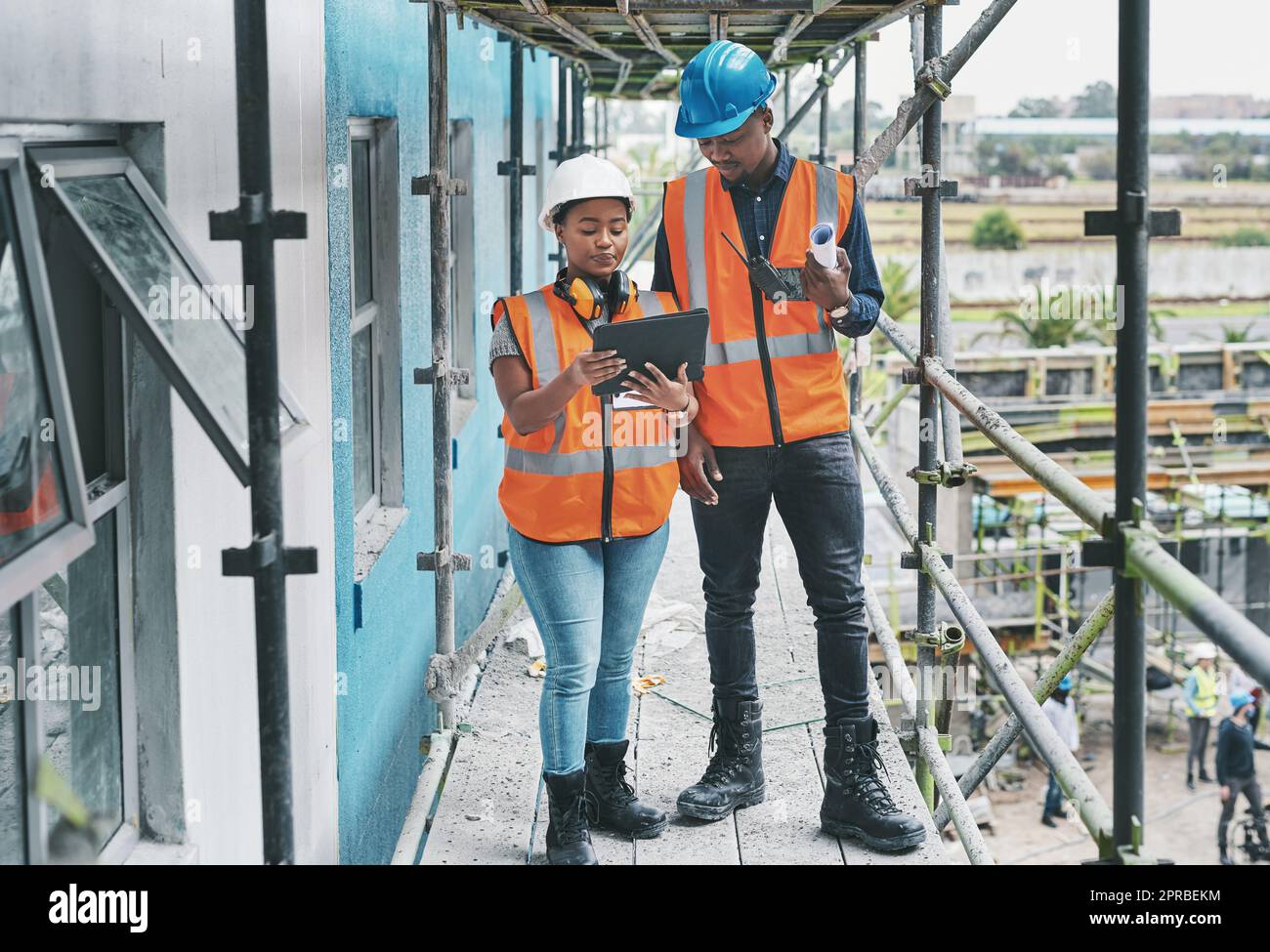 Cloud technology keeps all your data secure and accessible. a young man and woman using a digital tablet while working at a construction site. Stock Photo