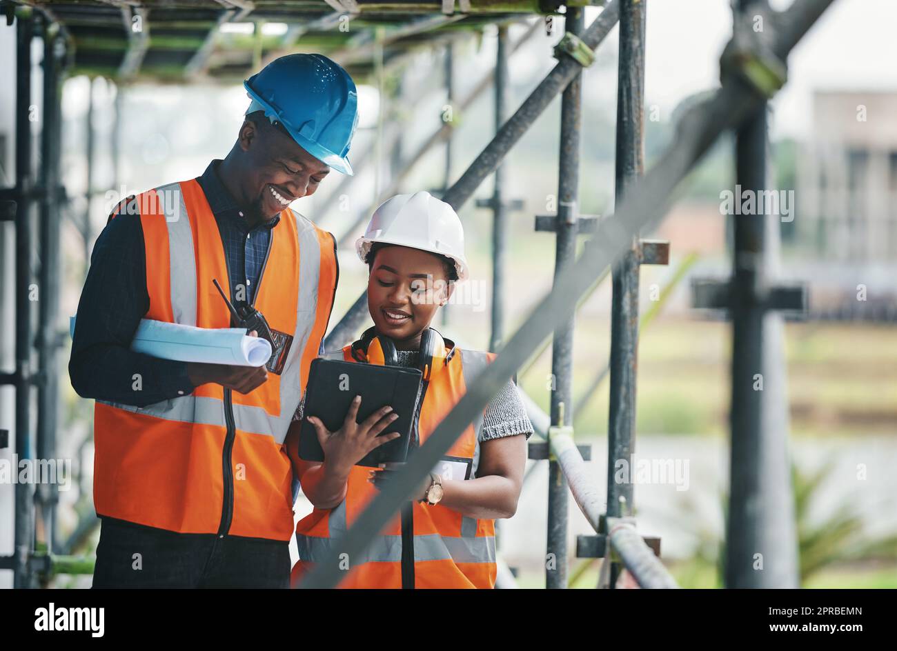 Collecting, storing and tracking all building compliance documentation. a young man and woman using a digital tablet while working at a construction site. Stock Photo
