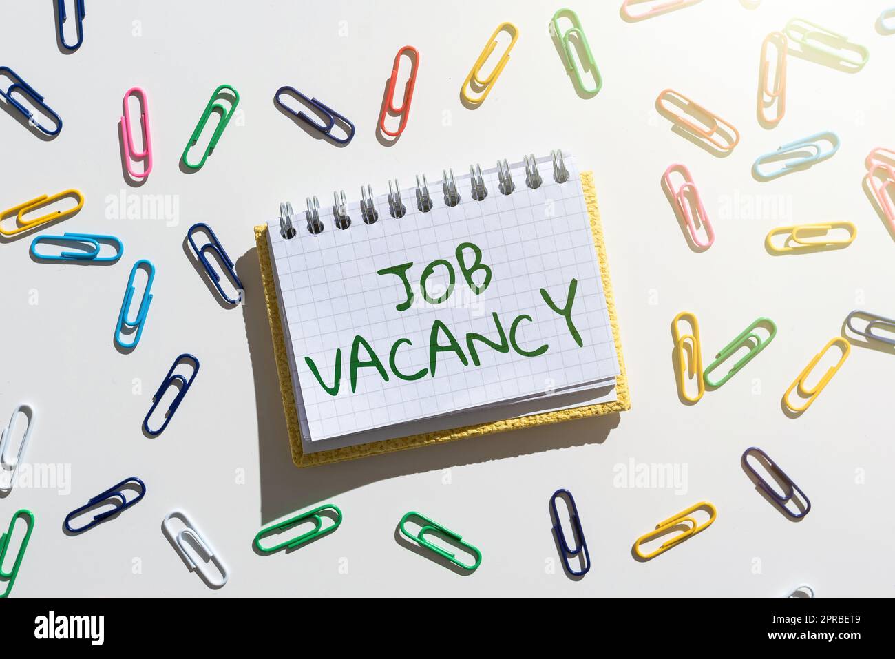 Conceptual display Job Vacancy. Conceptual photo empty or available paid place in small or big company Important Message Written On Notebook With Colorful Paperclips Around. Stock Photo