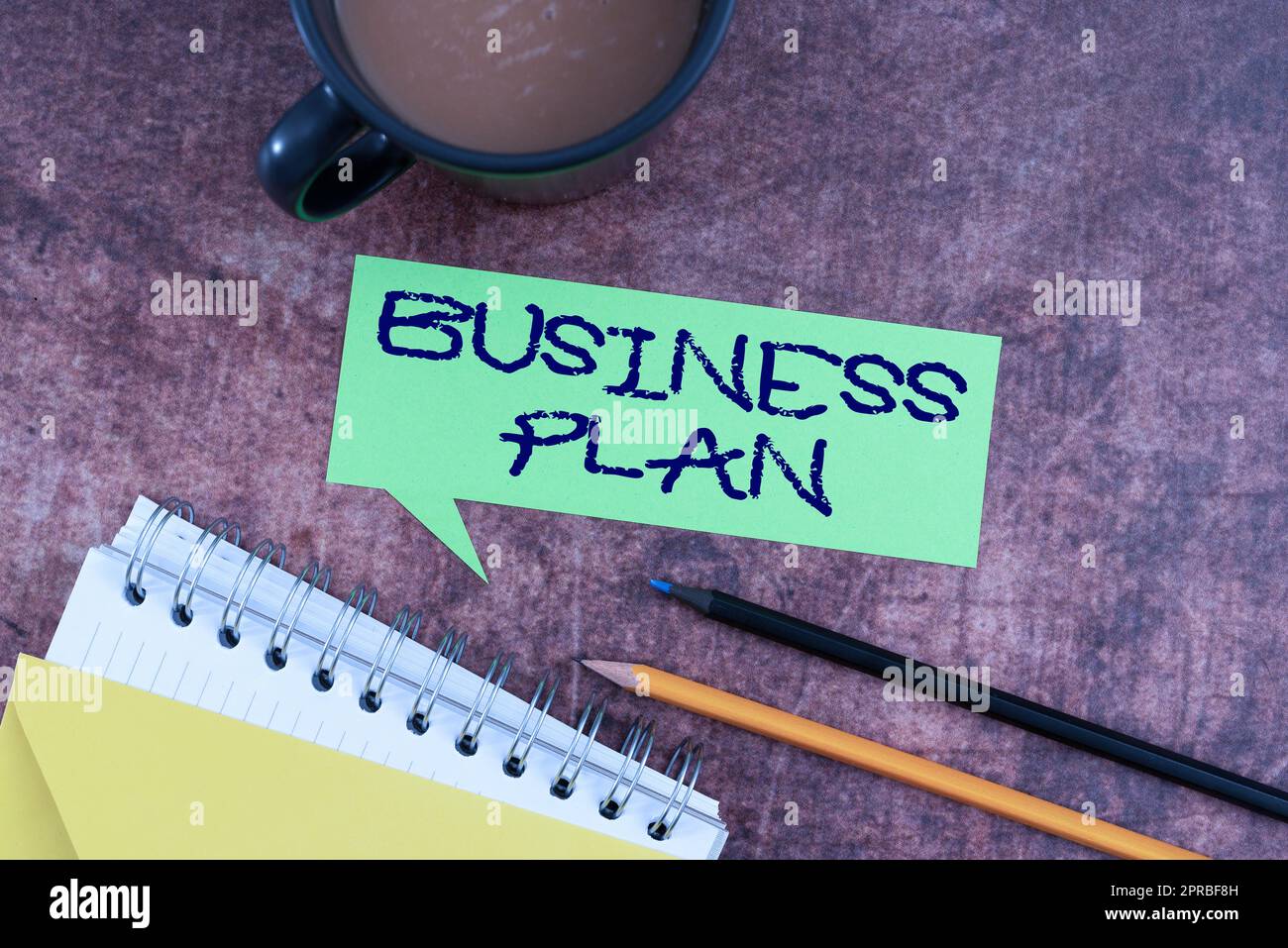 Sign displaying Business Plan. Word for Structural Strategy Goals and Objectives Financial Projections Speech Bubble With Spiral Book And Coffee Showing New Ideas For Business. Stock Photo