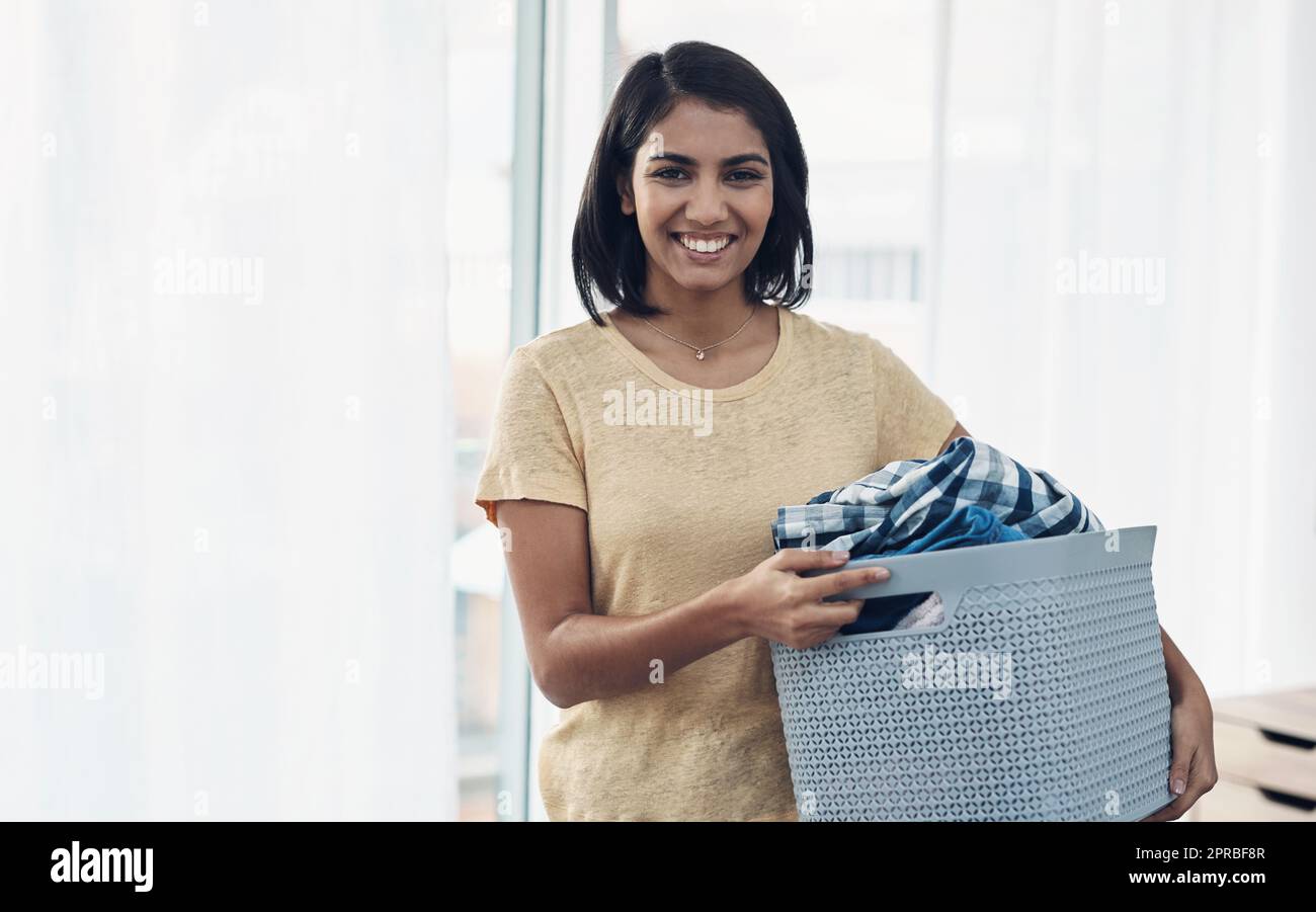 The cleaner the clothes the better. a young woman doing laundry at home