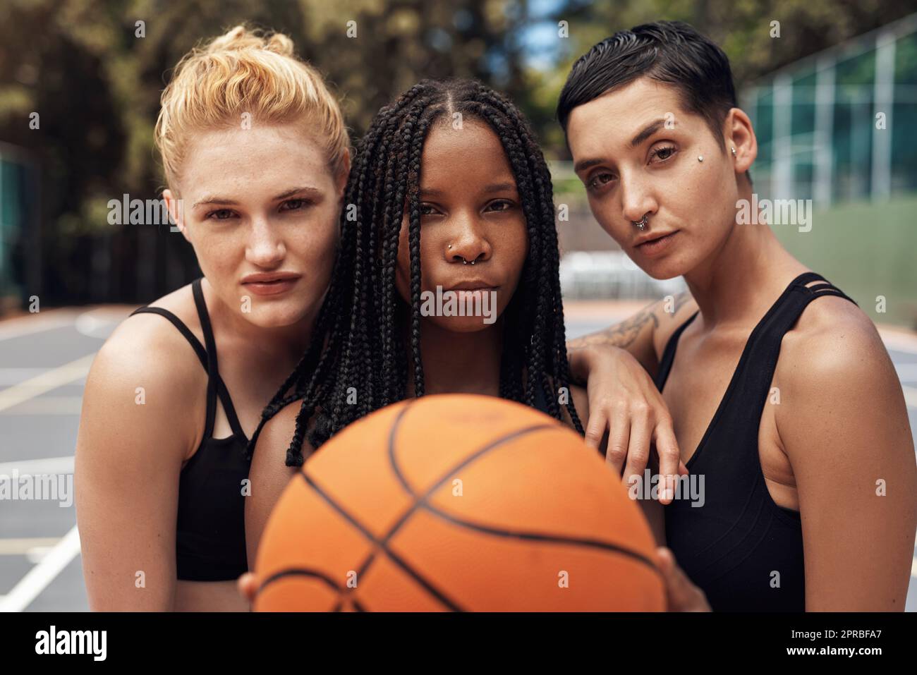 Staying focused on the game. Portrait of a group of sporty young women standing together on a sports court. Stock Photo