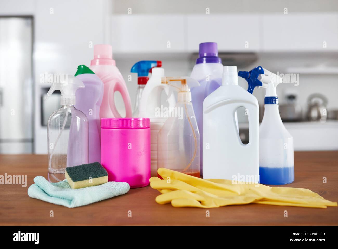 Top quality products for a cleaning pro. various cleaning products on a table in the kitchen at home. Stock Photo