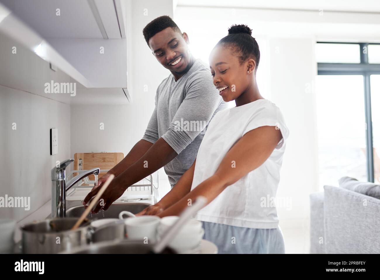Dirty dishes dont stand a chance. a young couple washing the dishes