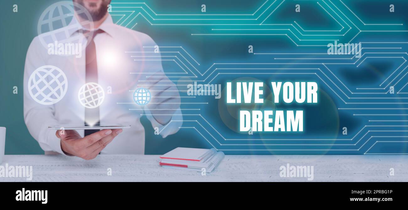 Text showing inspiration Live Your Dream. Conceptual photo Motivation be successful inspiration happiness achieve goals Businessman Holding Tablet And Presenting Crutial Messages In Office. Stock Photo