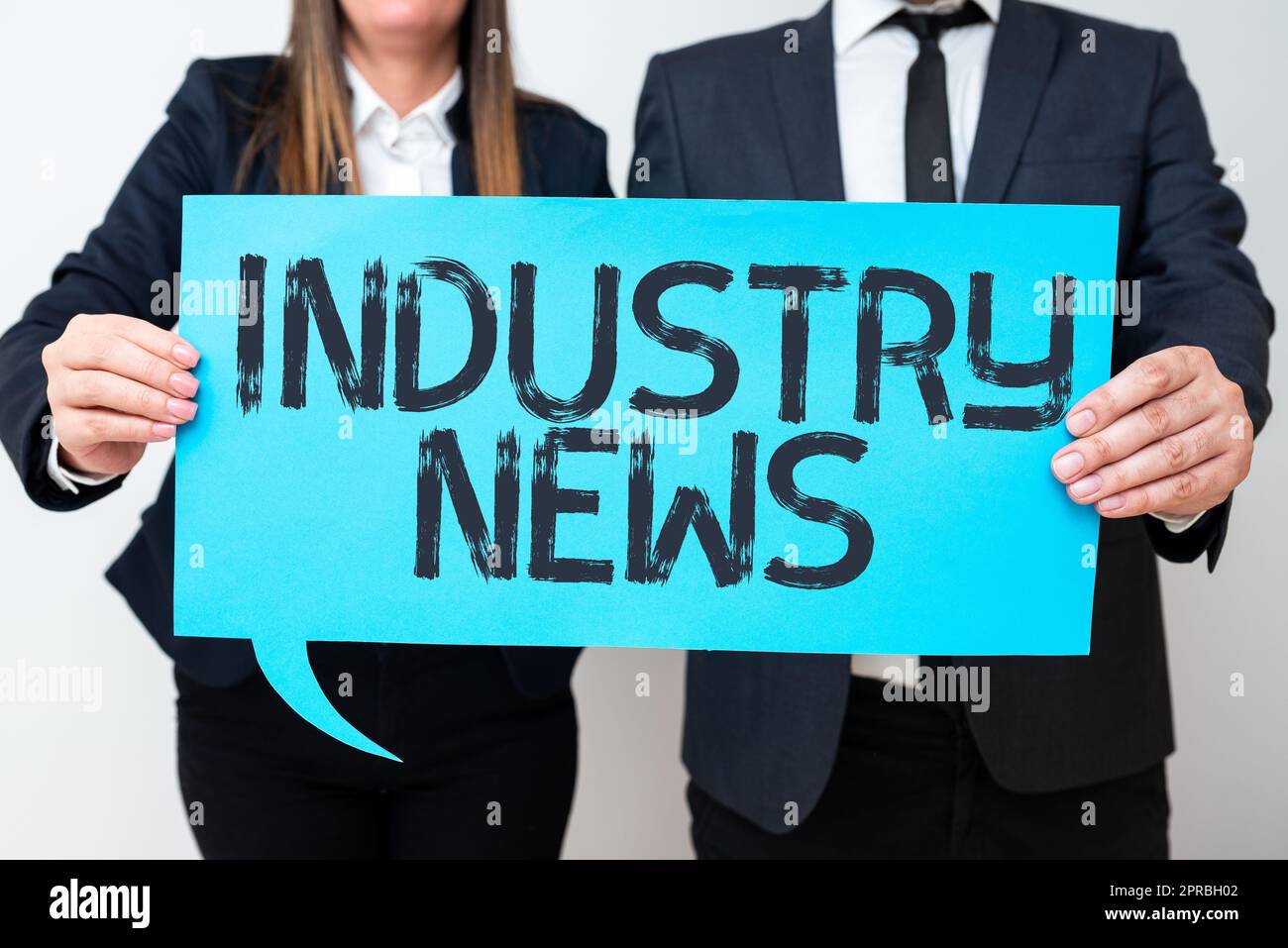Sign displaying Industry News. Business overview Technical Market Report Manufacturing Trade Builder Business Team Holding Important Information On Speech Bubble On Both Sides. Stock Photo