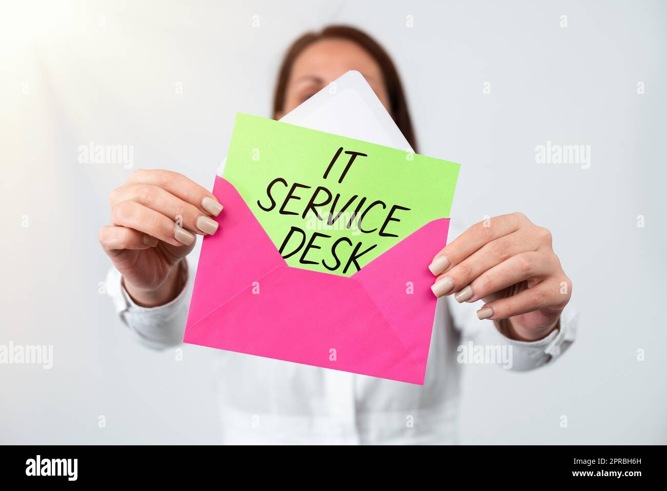 Writing displaying text It Service Desk. Conceptual photo Technological support online assistance help center Woman Holding Letter And Envelope Sending Important Information. Stock Photo