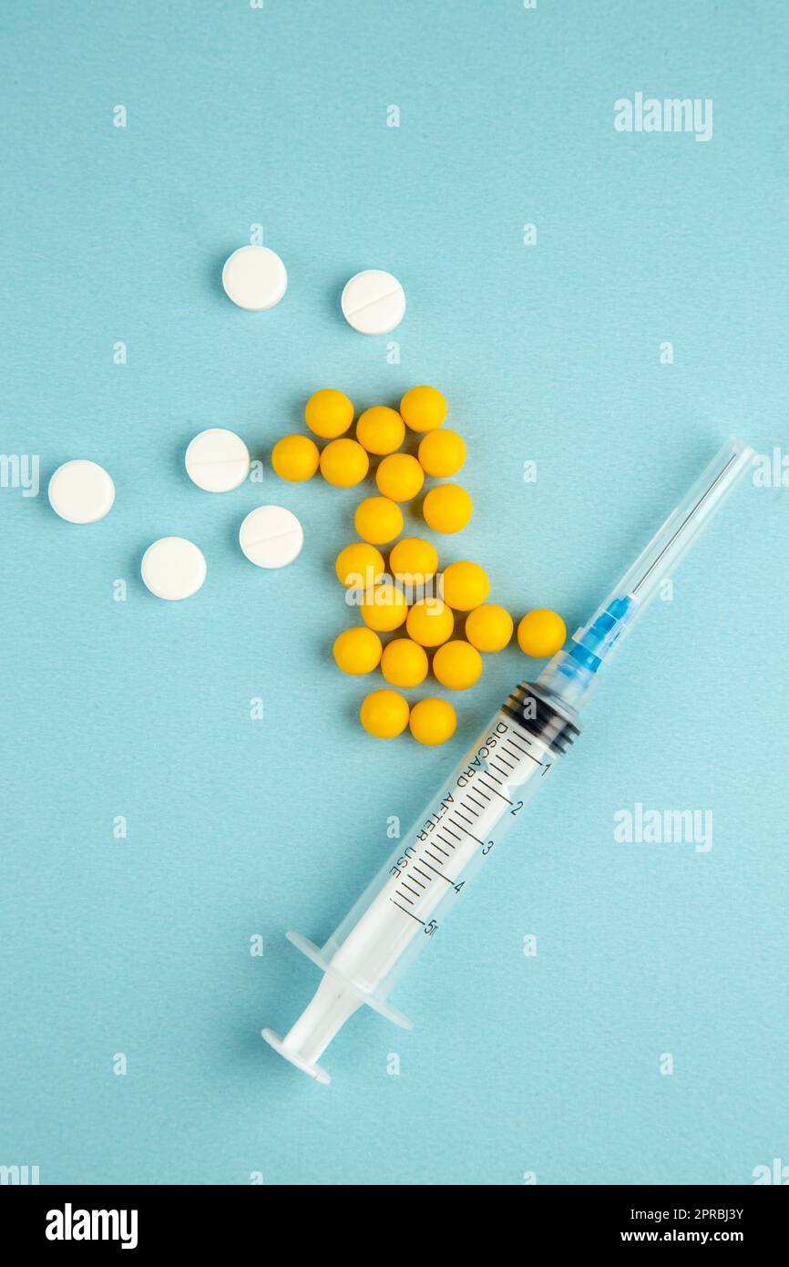 top view different pills with injection on blue background hospital ...
