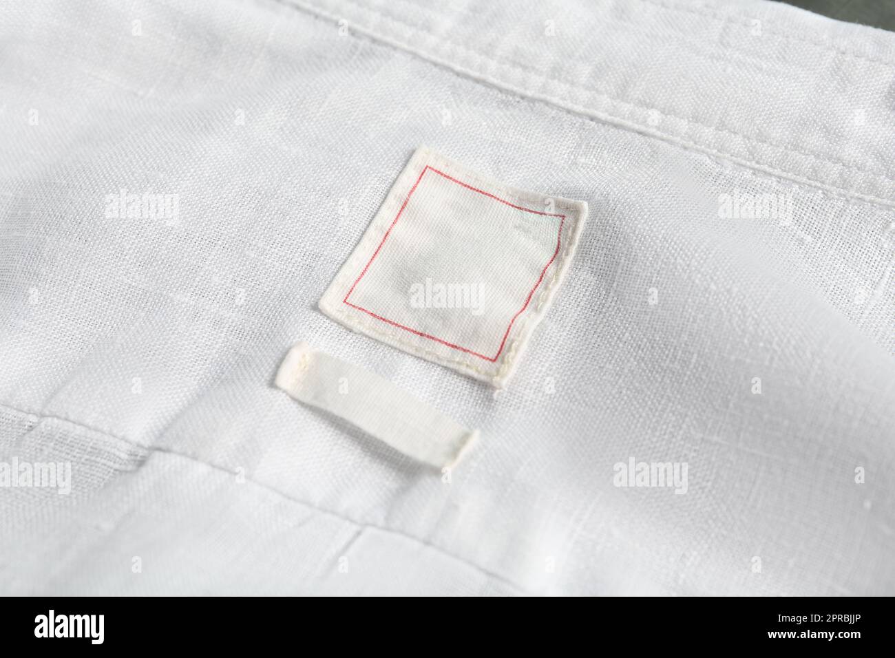 Blank clothing labels on white shirt, closeup Stock Photo Alamy