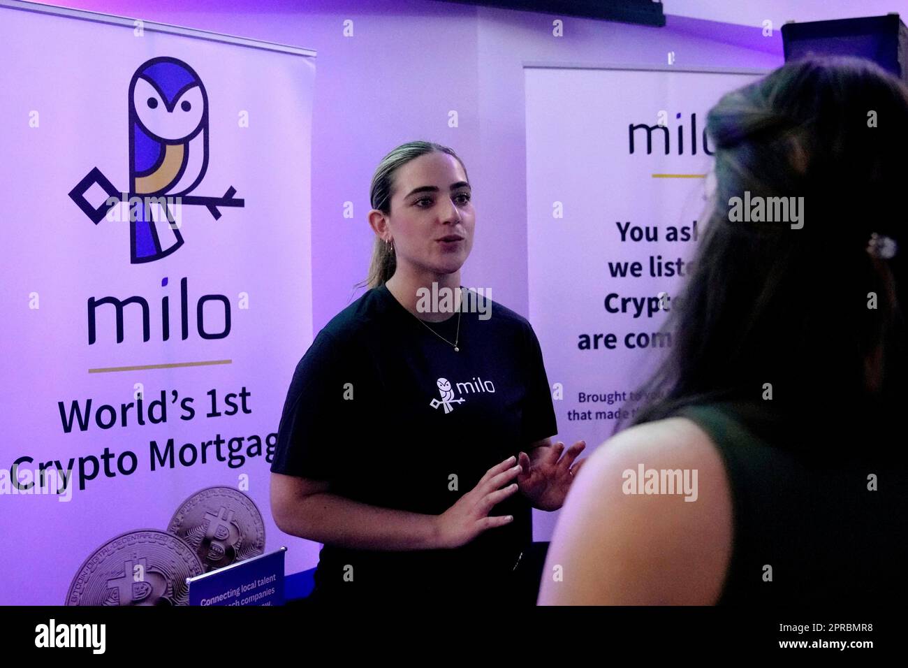 Alexia Zuloaga of Milo, a crypto mortgage company, left, speaks with a job  seeker at the Venture Miami Tech Hiring Fair at the Miami-Dade College,  Wolfson campus, Wednesday, April 26, 2023, in