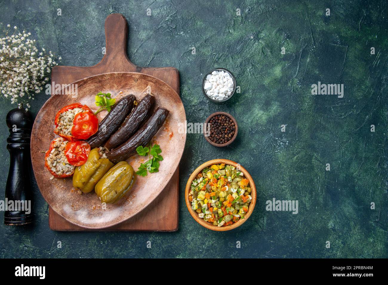 top view tasty vegetable dolma with black pepper shaker and salad on