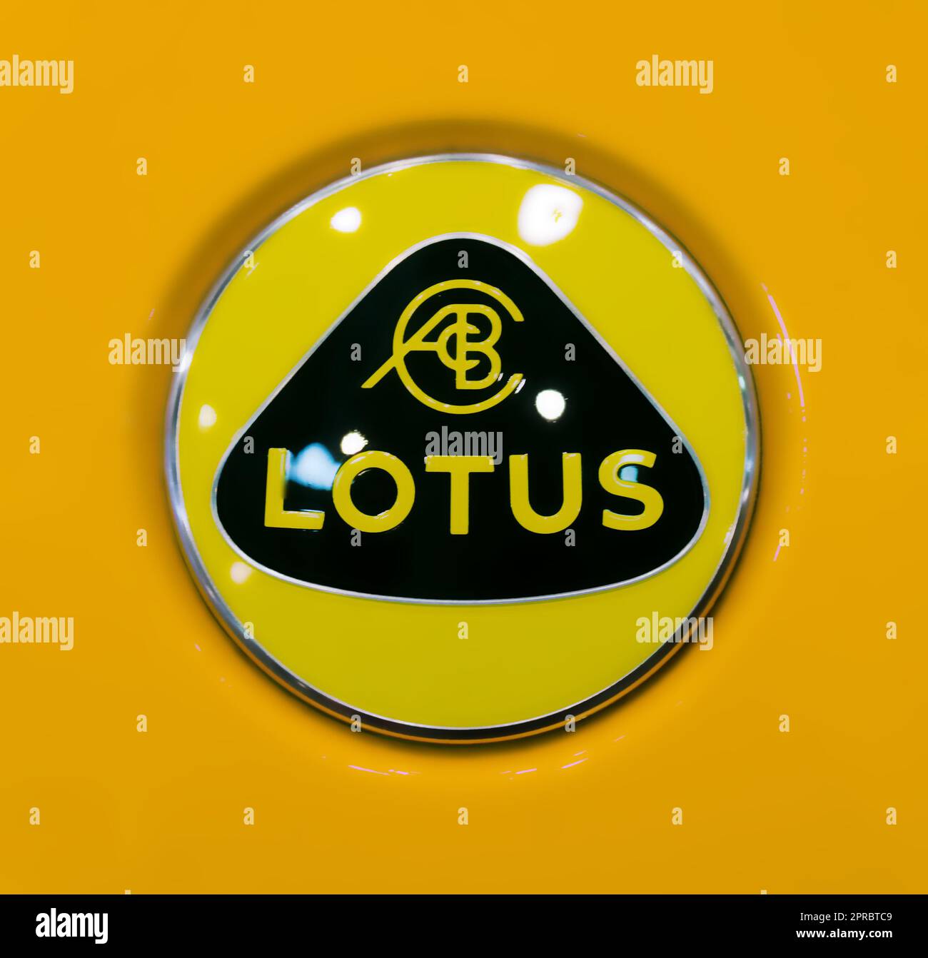 Toronto, Canada 02 25 2023 Yellow rounded logo of Lotus Cars Limited on orange hood of Lotus