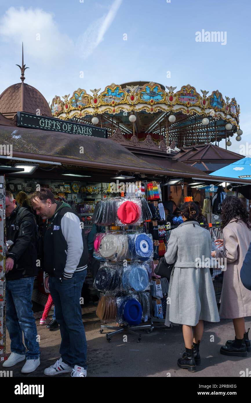 Tourists at the gift shop next to the Carousel of Eiffel Tower in Paris, France. March 25, 2023. Stock Photo