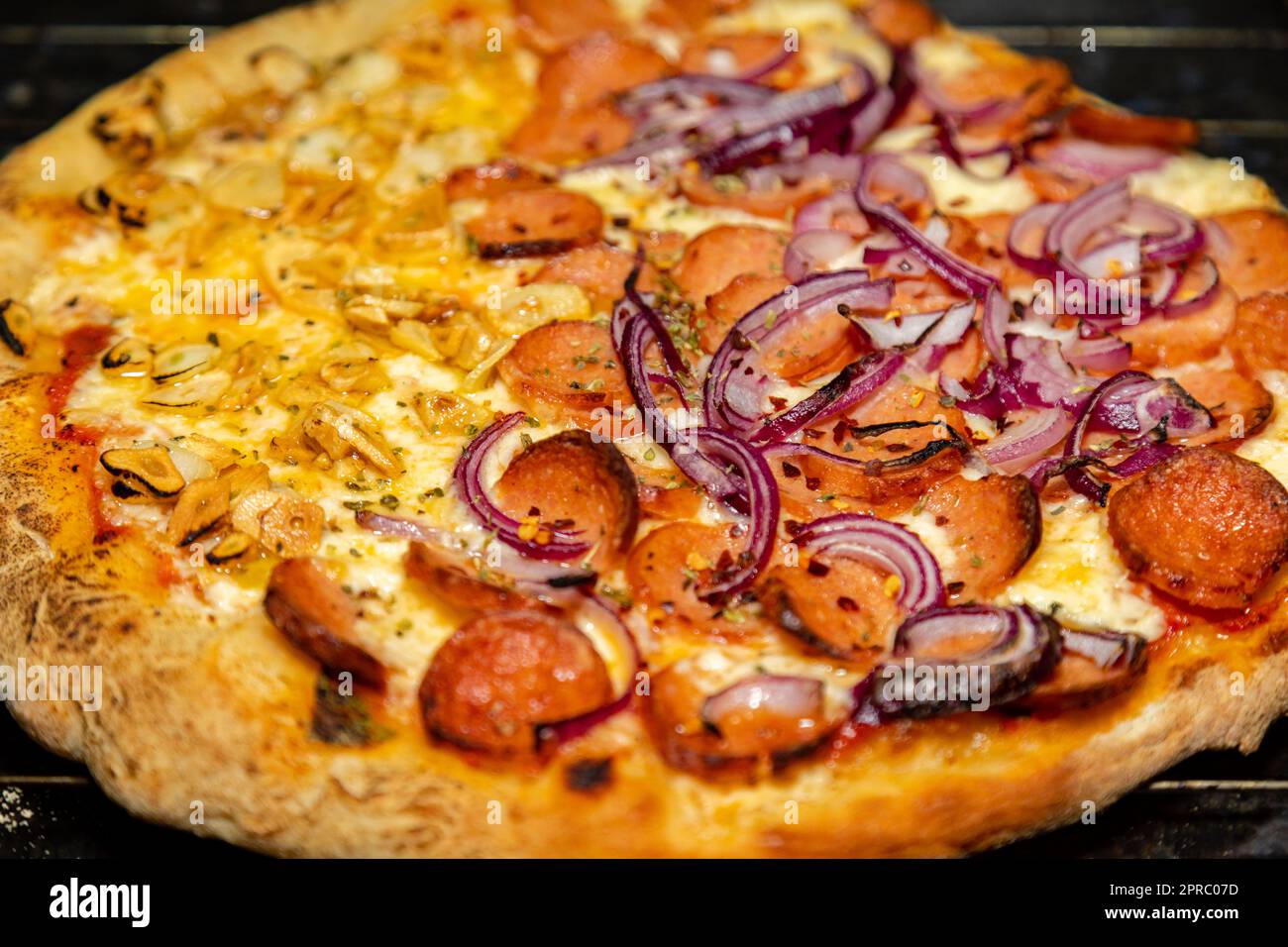 Traditional Pizza half garlic and oil and half pepperoni, typical of