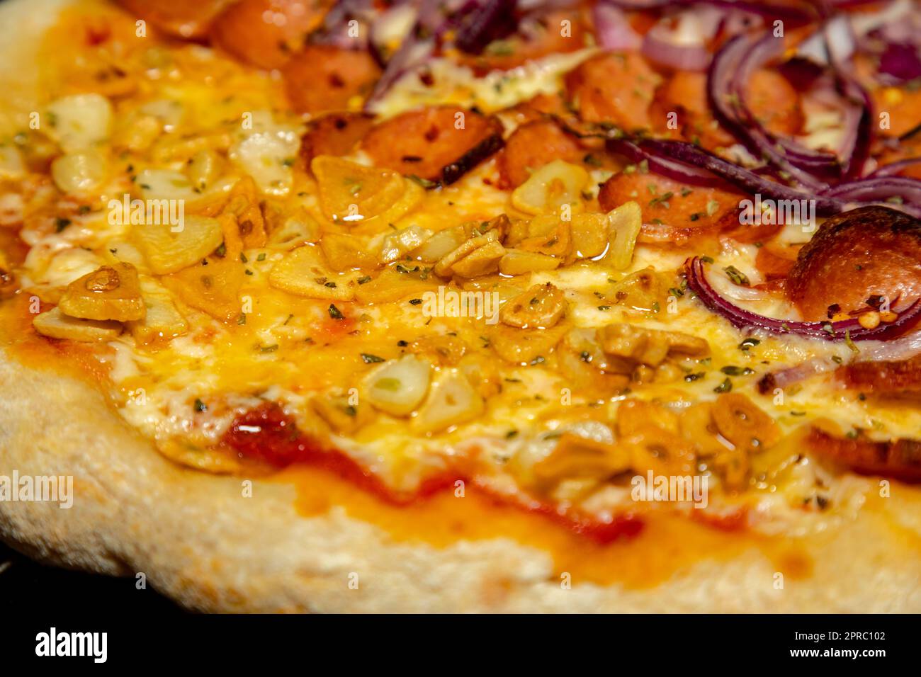 Traditional Pizza half garlic and oil and half pepperoni, typical of