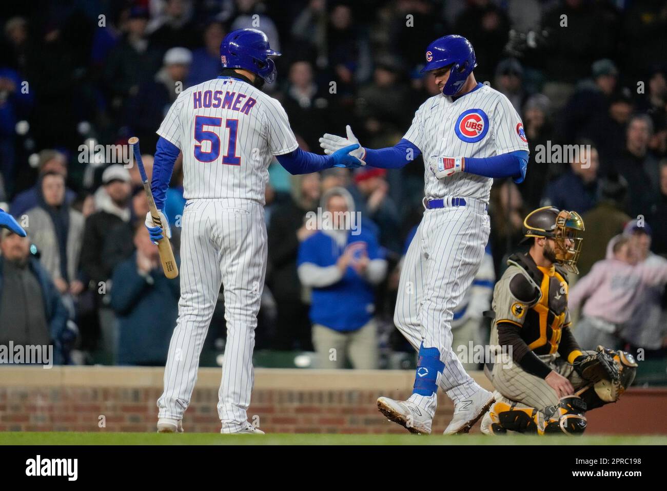 Chicago Cubs' Eric Hosmer, left, highfives Chicago Cubs' Trey Mancini