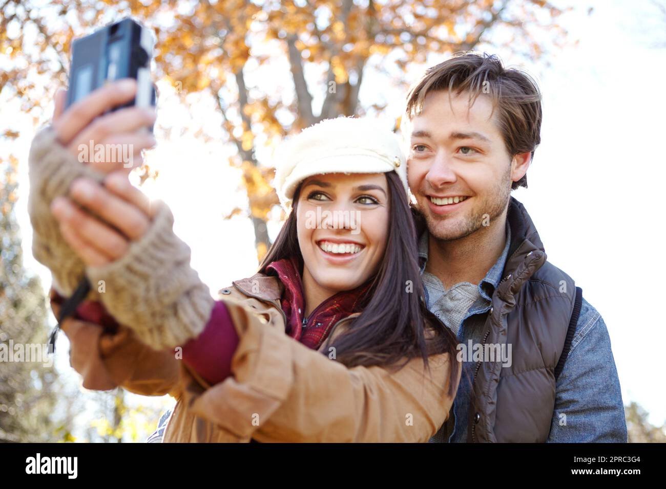Flashing their brightest smiles. A beautiful young woman standing