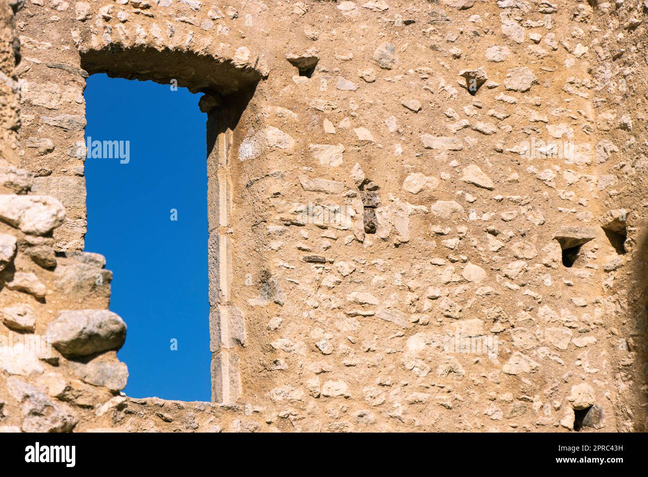 View of blue sky outside a window of 12th century French castle ruins Stock Photo