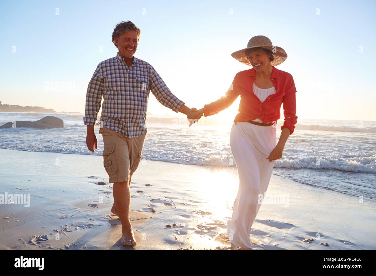 Hand in hand forever. a mature couple enjoying a late afternoon walk on ...
