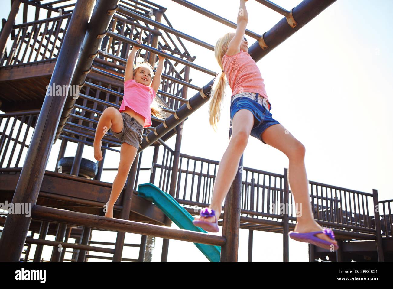 Play is our brains favorite way of learning. two little girls hanging