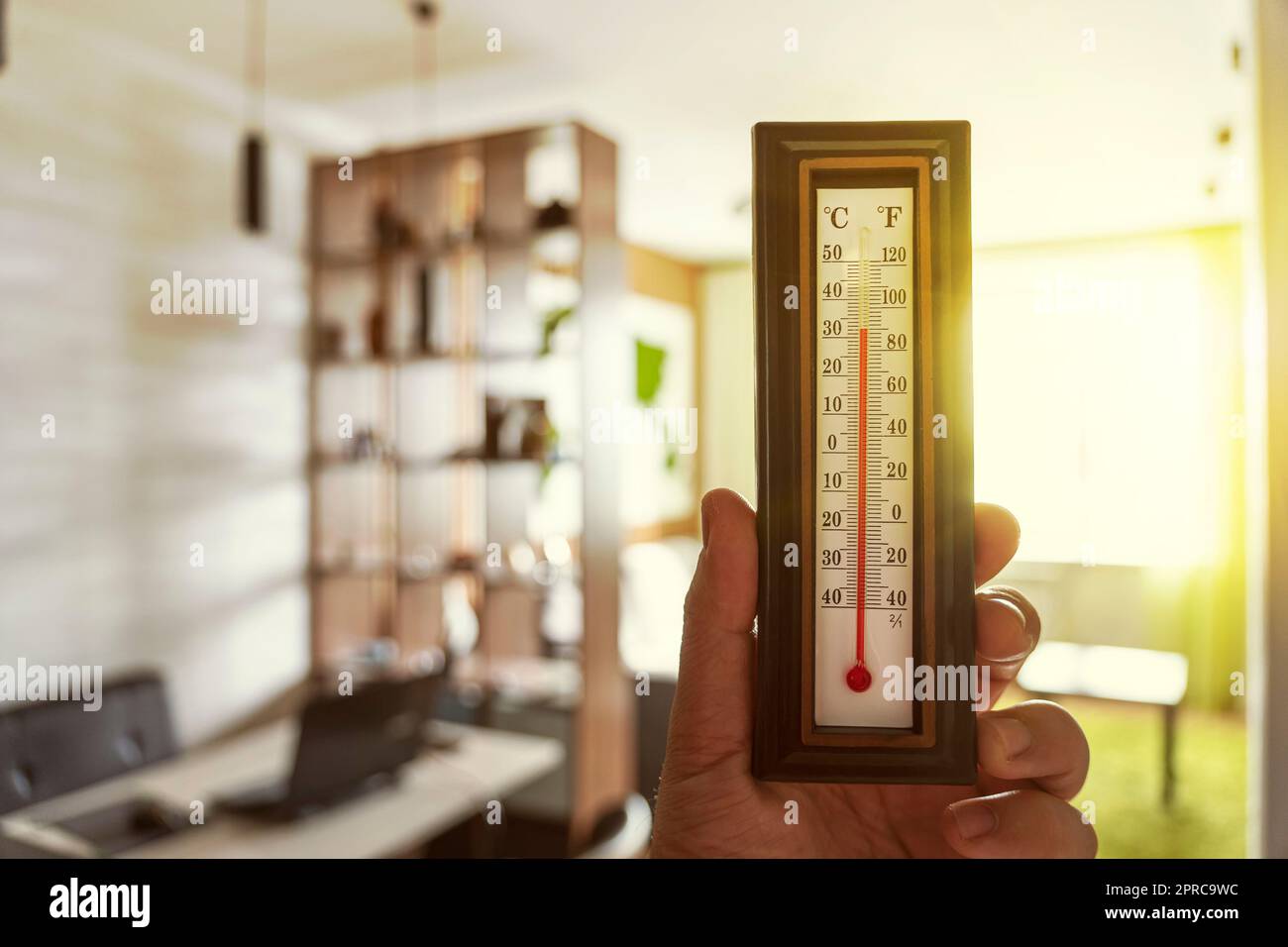 The thermometer outside the window shows a very hot air temperature, heated  by the rays Stock Photo by skaron2022