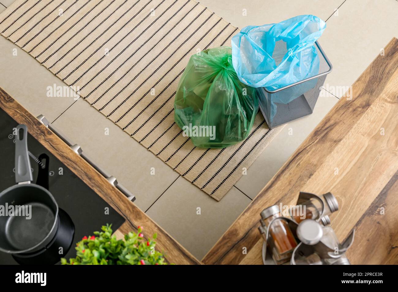 Empty trash bin and full garbage bag in kitchen Stock Photo Alamy