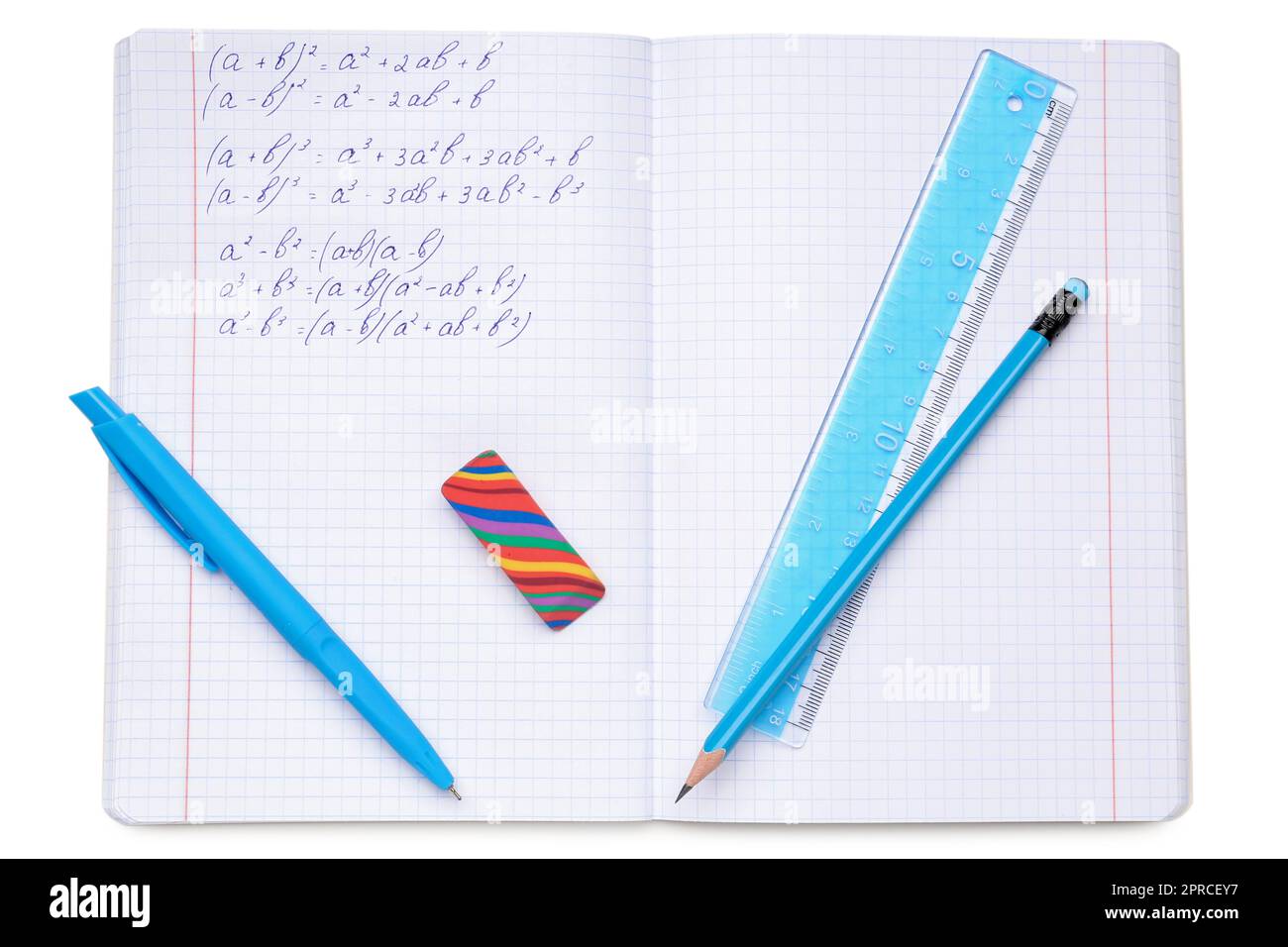 Copybook with maths formulas and stationery isolated on white background Stock Photo
