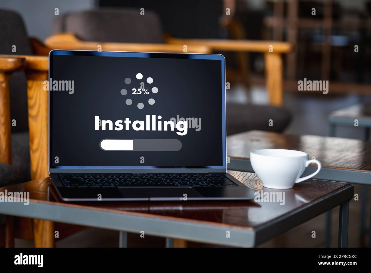man installing Software Update On Mobile Phone And Laptop digital technology communication Stock Photo