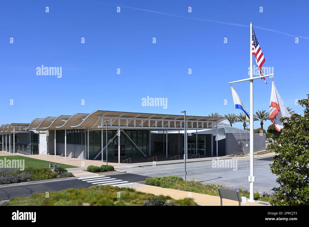 NEWPORT BEACH, CALIFORNIA - 21 APR 2023: Newport Beach City Hall in the Civic Center with mast and flags. Stock Photo