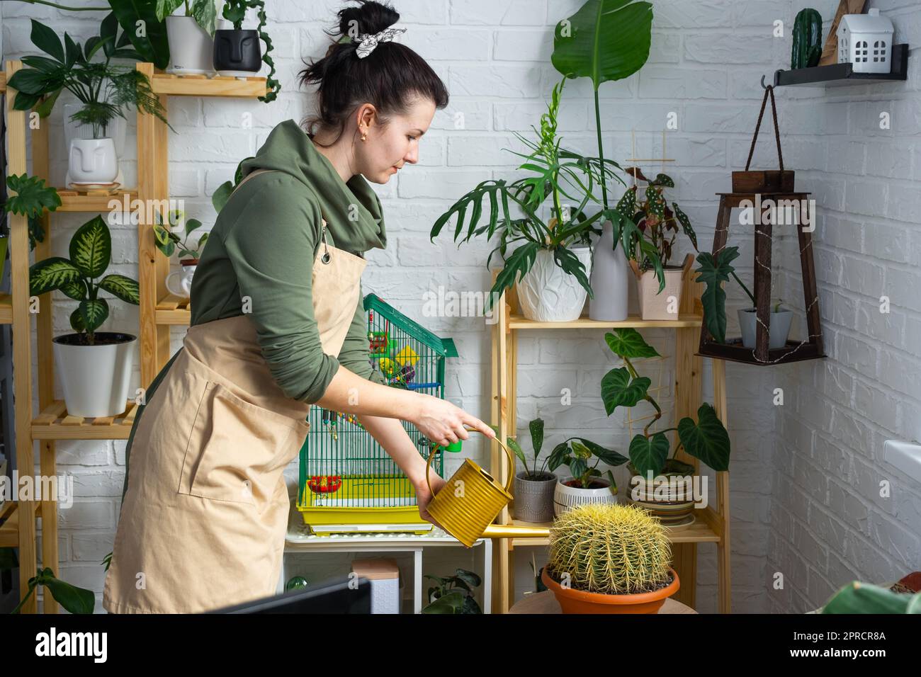 A woman waters home plants from her collection of rare species from a