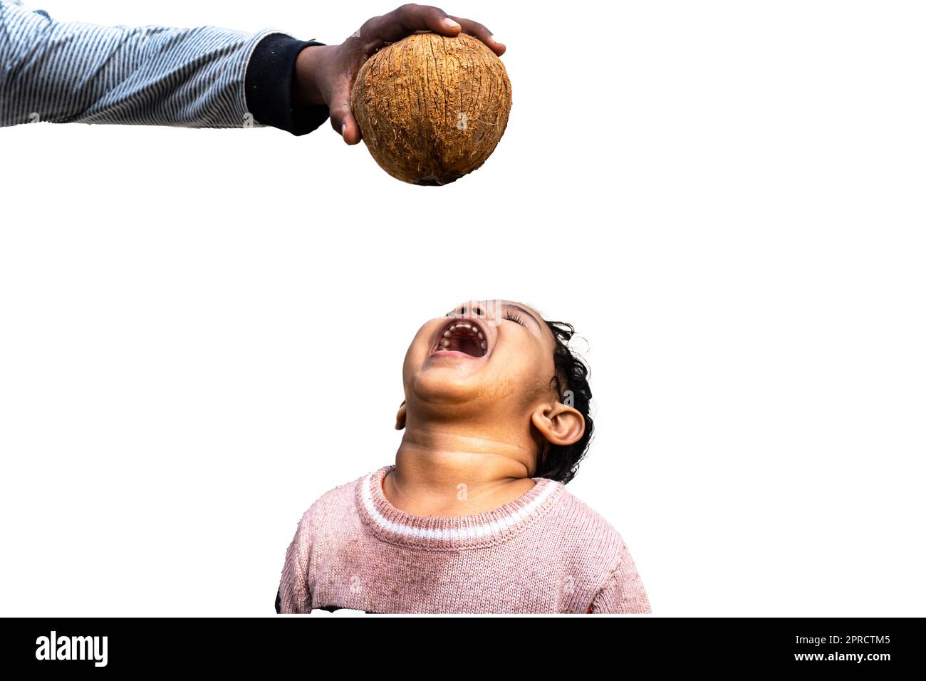 Asian Little boy child drinks coconut water from a fresh coconut. Stock Photo