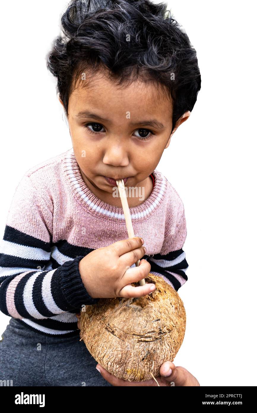 Cute little boy drinks coconut water with pleasure. Stock Photo