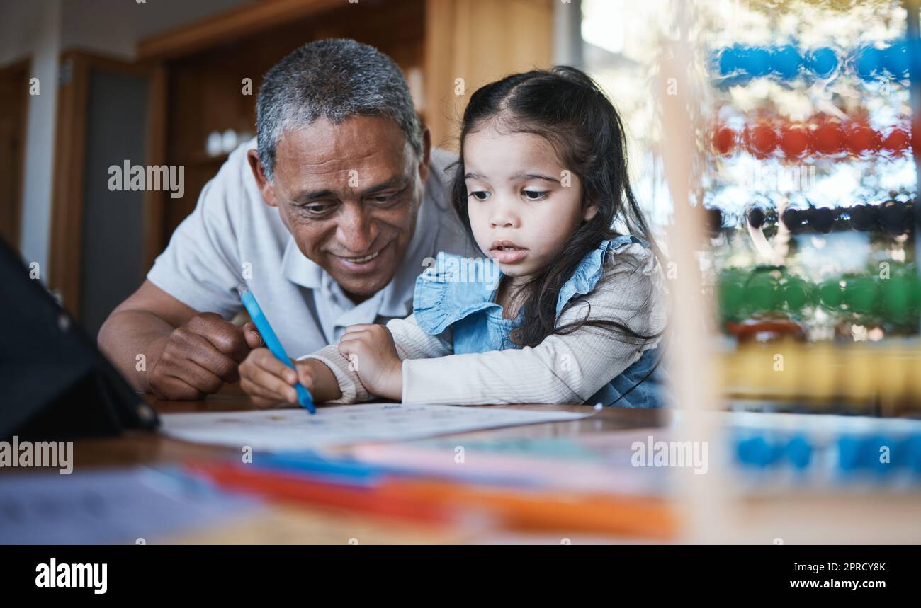 Learning, drawing and grandfather with girl in home for studying, homeschool and homework. Education, child and happy grandpa teaching kid, knowledge Stock Photo