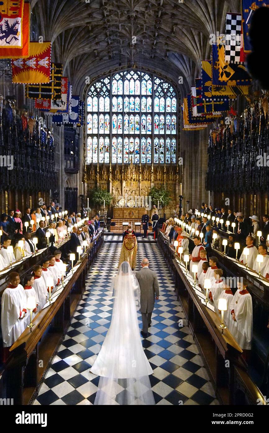 File photo dated 19/05/18 of the Prince of Wales walking Meghan Markle up the aisle of St George's Chapel at Windsor Castle for her wedding to Prince Harry. Photos from every year of the King's life have been compiled by the PA news agency, to celebrate Charles III's coronation. Issue date: Thursday April 27, 2023. Stock Photo
