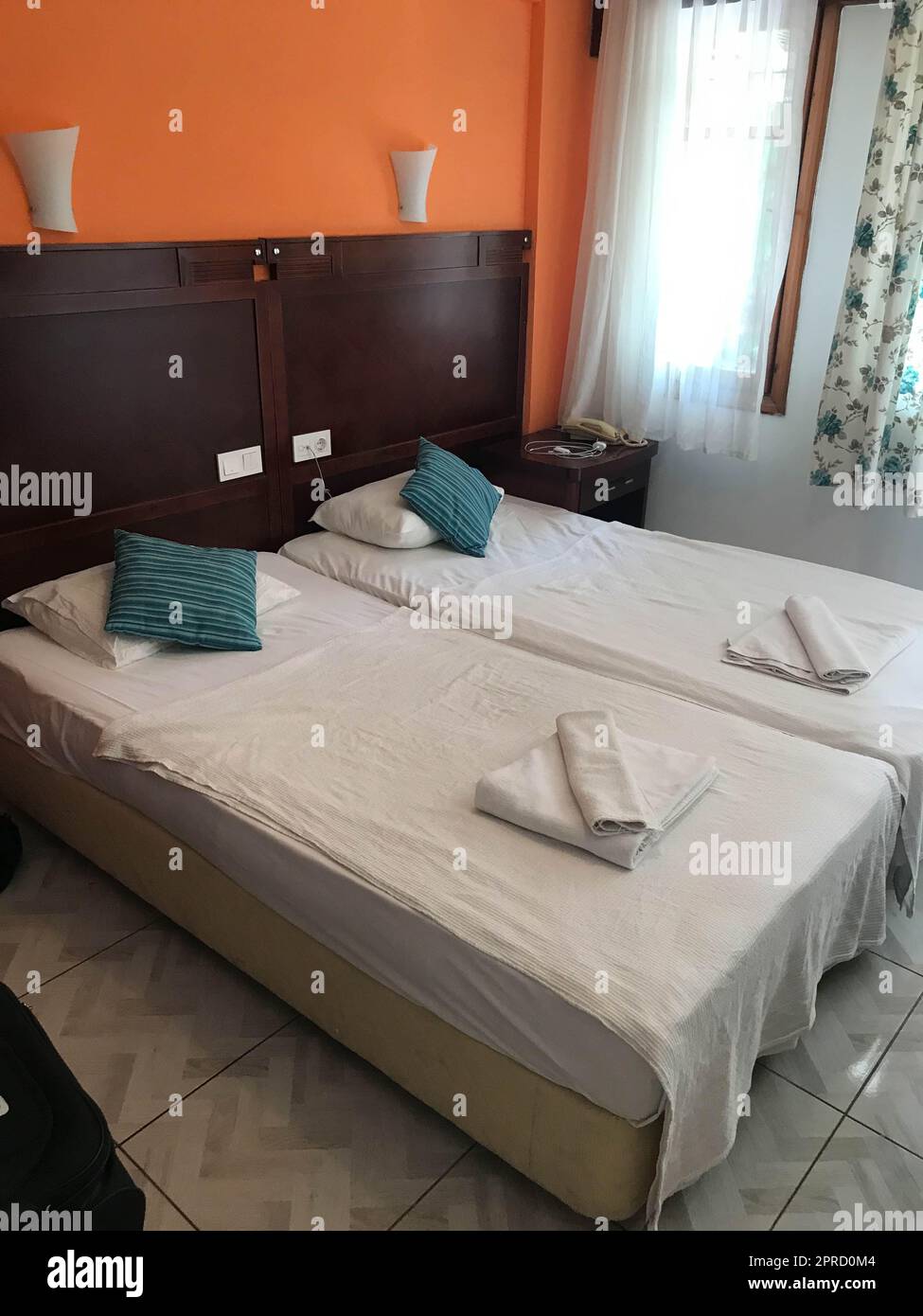 A hotel room, bedroom with two beds, curtain, lighting front view at