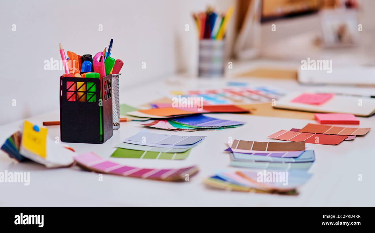 Lots of colour to spark lots of creativity. a notebook and various tools at a creative workstation. Stock Photo