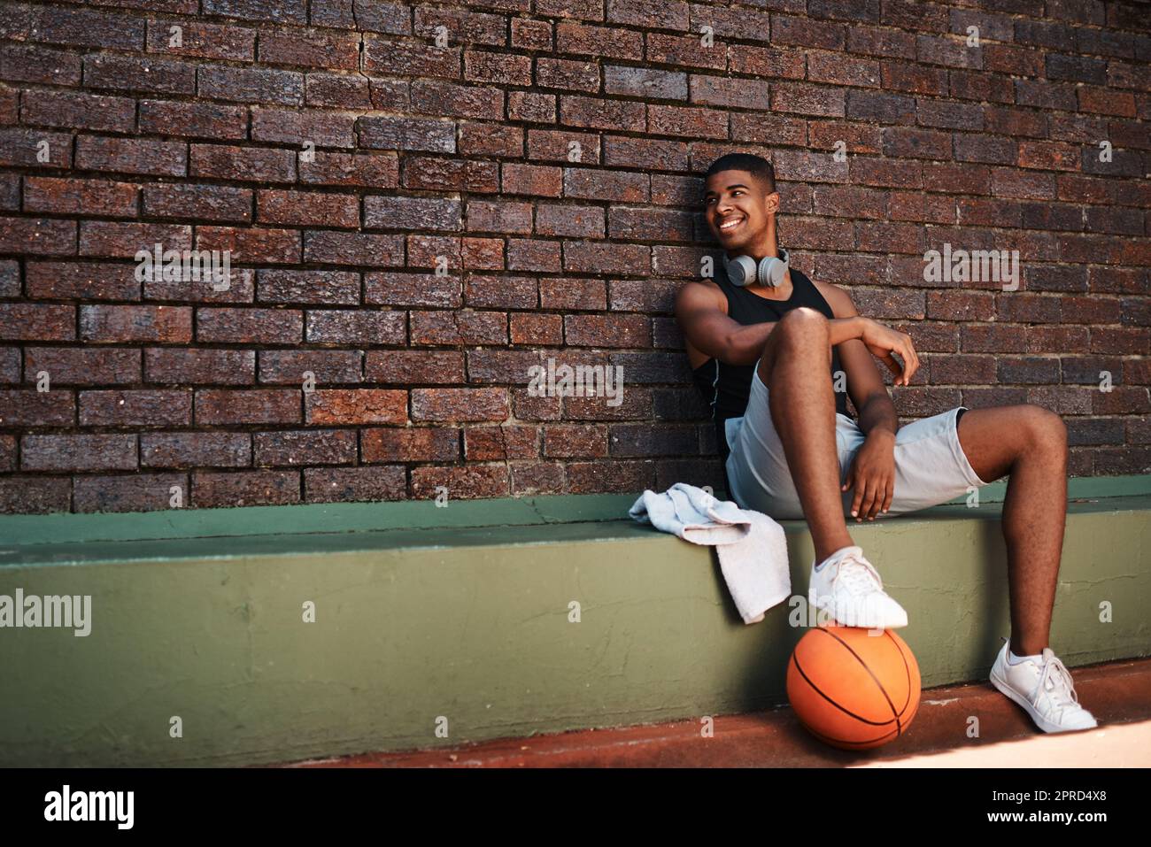 I believe in shooting for your goals. a sporty young man taking a break