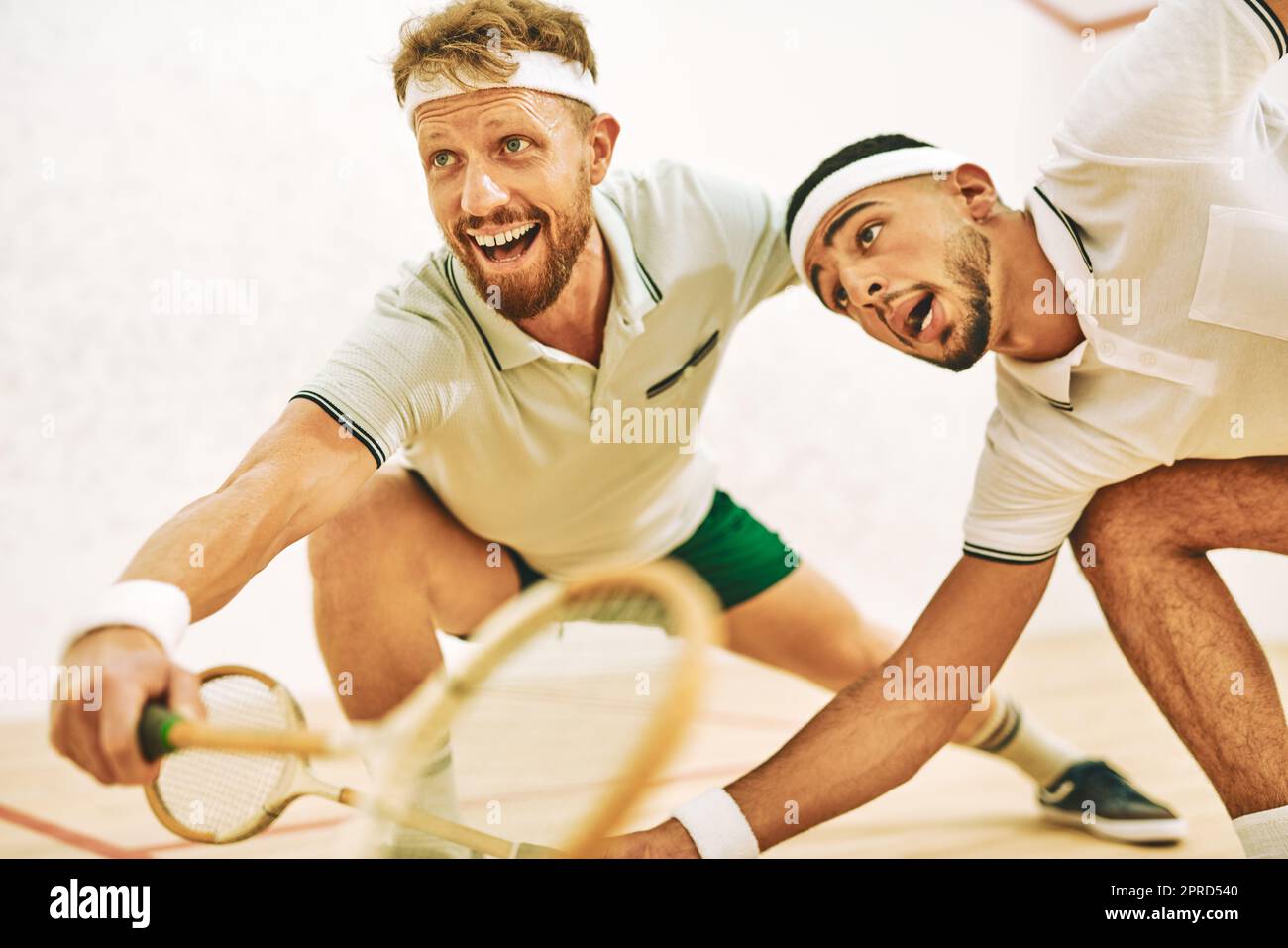 Every second counts on the squash court. two young men playing a game of squash. Stock Photo