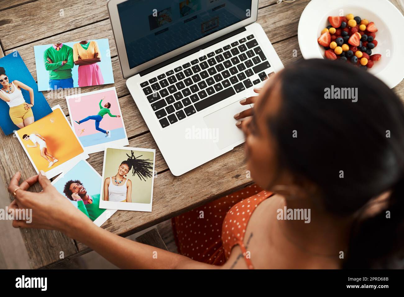 I think this colour would contrast well. High angle shot of an unrecognizable businesswoman sitting in her home office and going through polaroids for her blog. Stock Photo