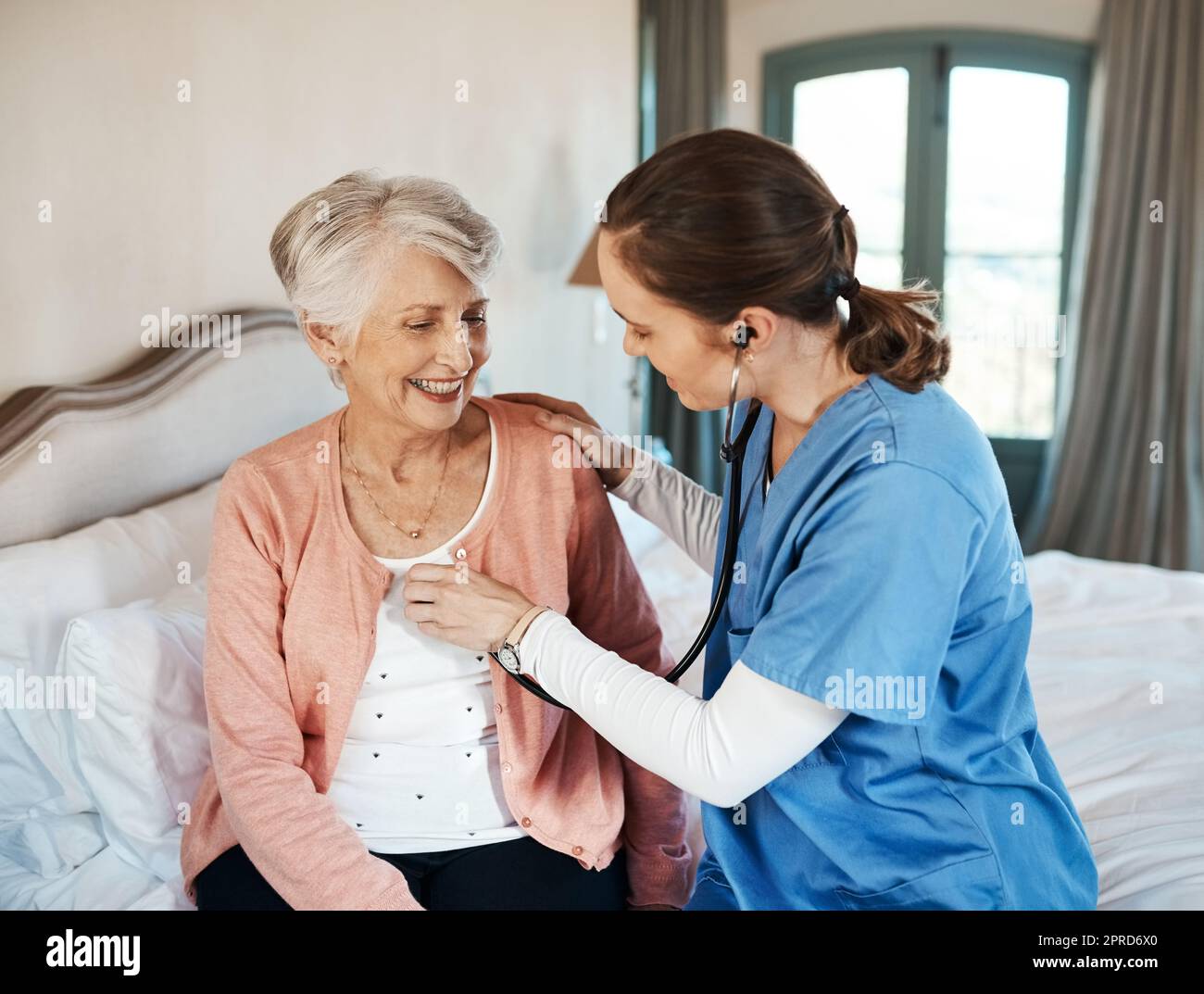Her favourite doctor does house calls. a senior woman getting a checkup from a young nurse in a retirement home. Stock Photo