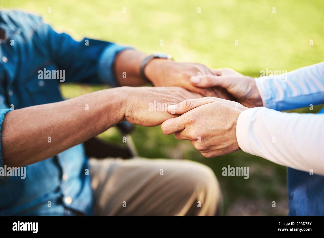 Im here to bring happiness. an unrecognizable woman holding a senior mans hands. Stock Photo
