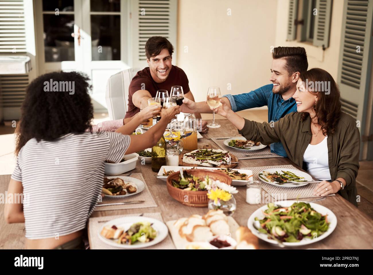 Nothing bring people closer together like food. a group of people sharing a meal Stock Photo Alamy