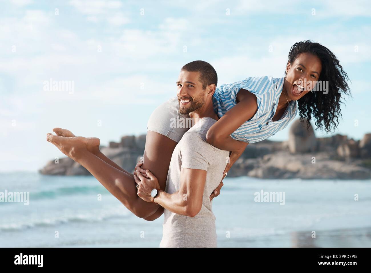 Theres no bigger joy than being together. Portrait of a young couple enjoying some quality time together at the beach. Stock Photo