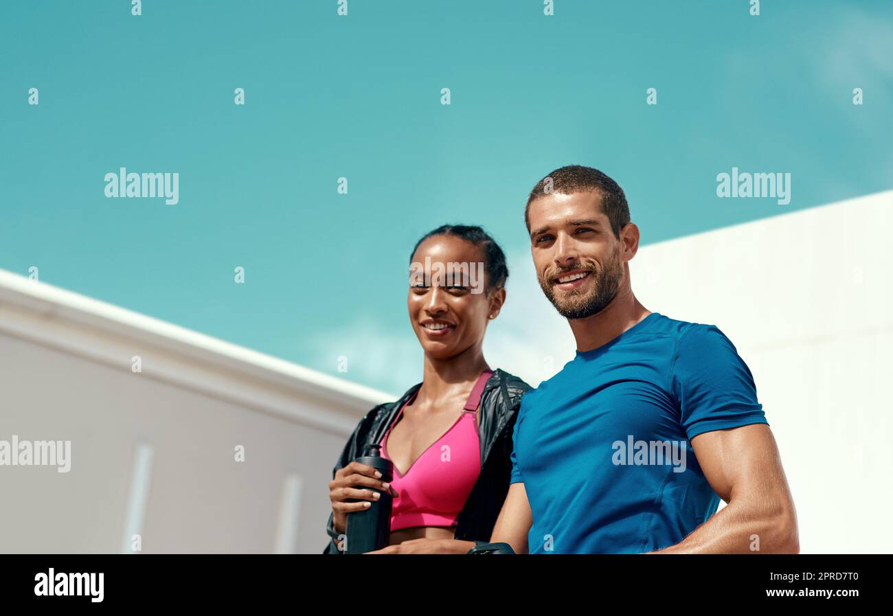 Youre one workout away from a good mood. two sporty young people standing together. Stock Photo