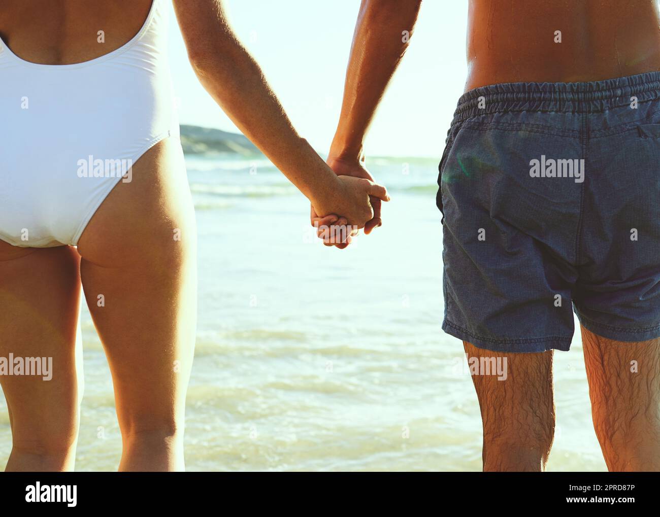True love is staying by each others side. Closeup shot of a couple holding hands at the beach. Stock Photo