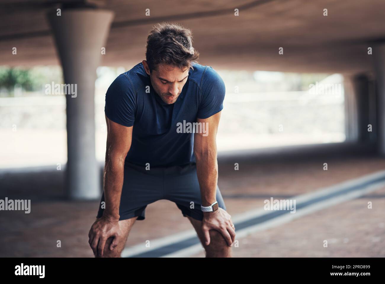 Intense Break Talk about an intense workout. a sporty young man taking a break while ...