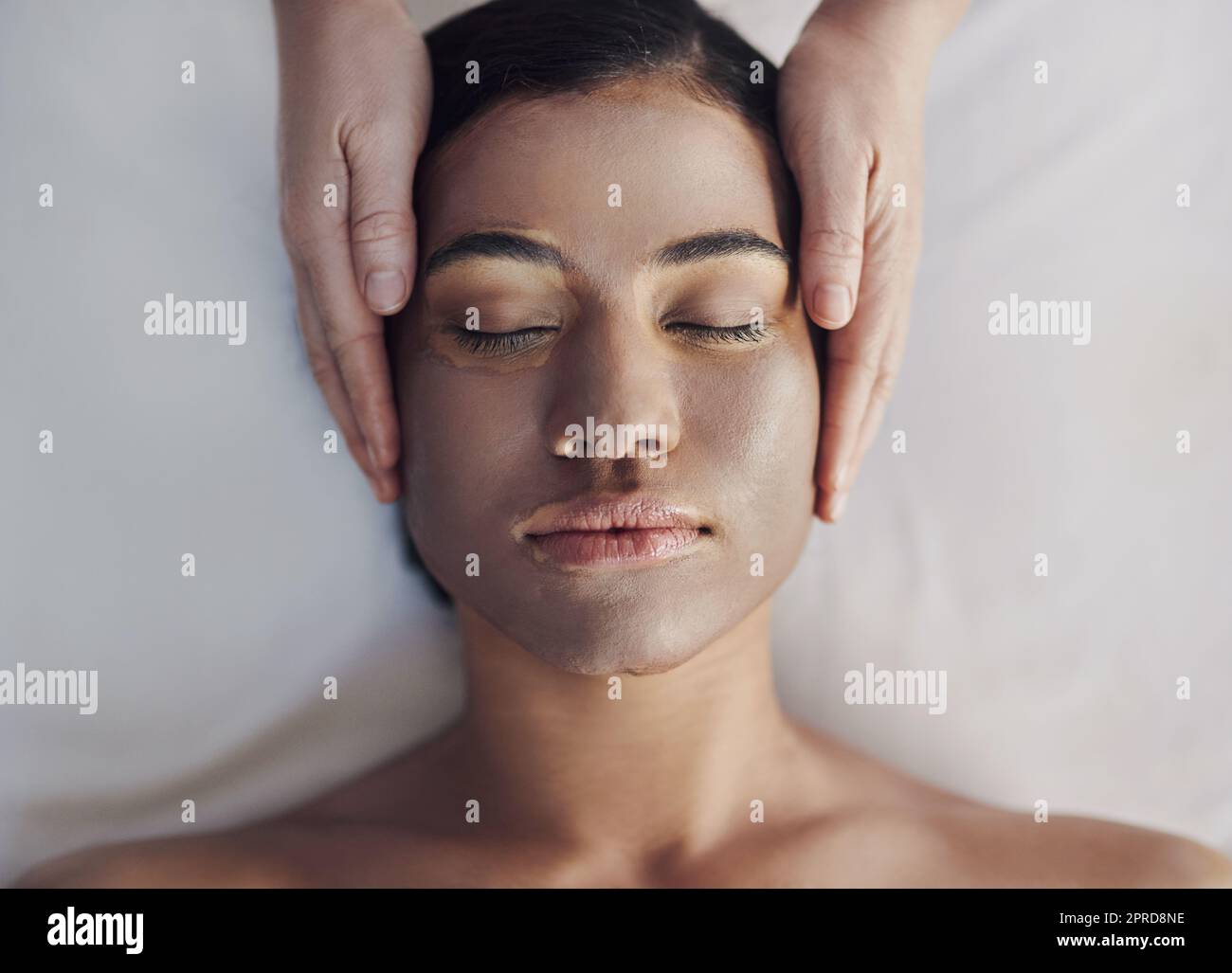 Glowing skin needs lot of nourishment. a young woman getting a facial treatment at a spa. Stock Photo